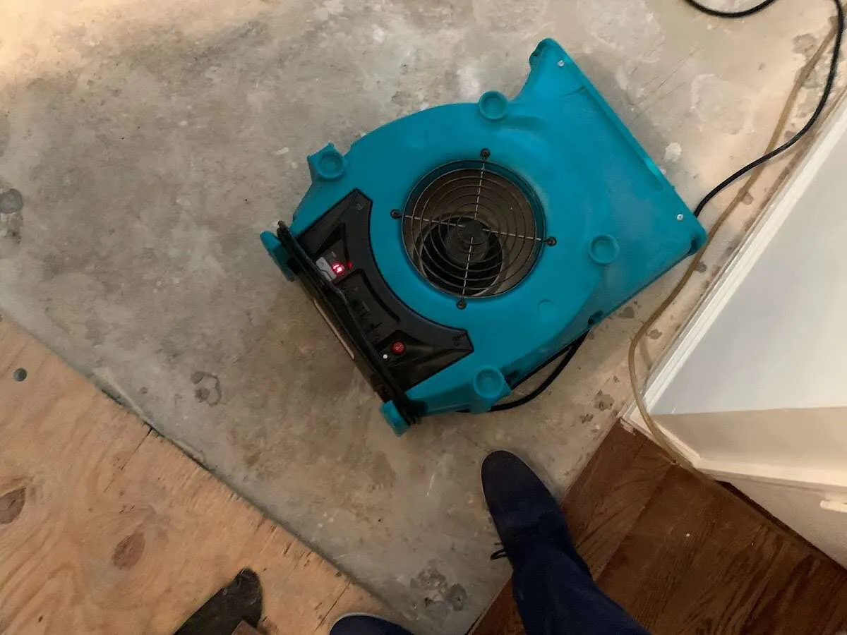 Air mover drying subfloor during Leak Detection & Repair in Ramapo